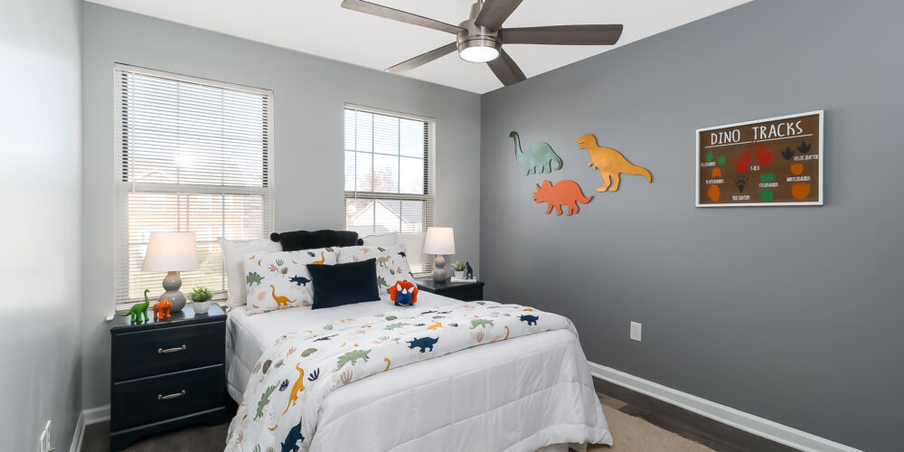 Bedroom of staged St. Charles MO home designed to look like a boy's room who loves dinosaurs