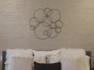 Still 2025-10-20 181133_1.11.1 Master bedroom of a home in Clayton, MO. The room is staged with matching end tables, lamps, and decorative pillows in white and black to match the room's tones.