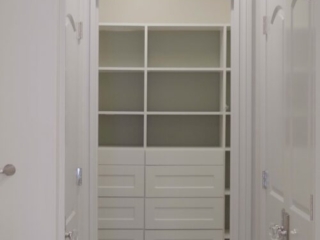 Still 2025-10-20 181133_1.13.1 The master bathroom of a home in Clayton, MO. It has been professionally staged and features artwork depicting flowers on the wall, in addition to white flowers adorned on the bathroom sink.