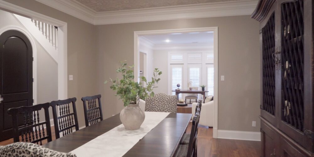 Still 2025-10-20 181133_1.5.1 Alternate view of dining room in Clayton, MO, featuring white leopard print chairs at the ends.