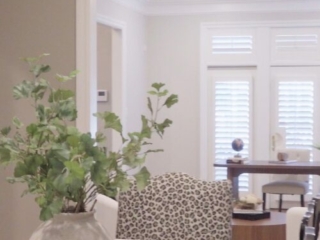 Still 2025-10-20 181133_1.5.1 Alternate view of dining room in Clayton, MO, featuring white leopard print chairs at the ends.