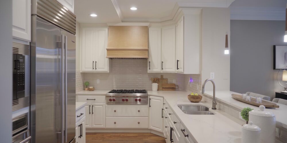 Still 2025-10-20 181133_1.6.1 Luxury kitchen of a home in Clayton MO that has been staged, with white cabinetry and stainless steel appliances.