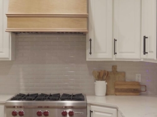 Still 2025-10-20 181133_1.6.1 Luxury kitchen of a home in Clayton MO that has been staged, with white cabinetry and stainless steel appliances.